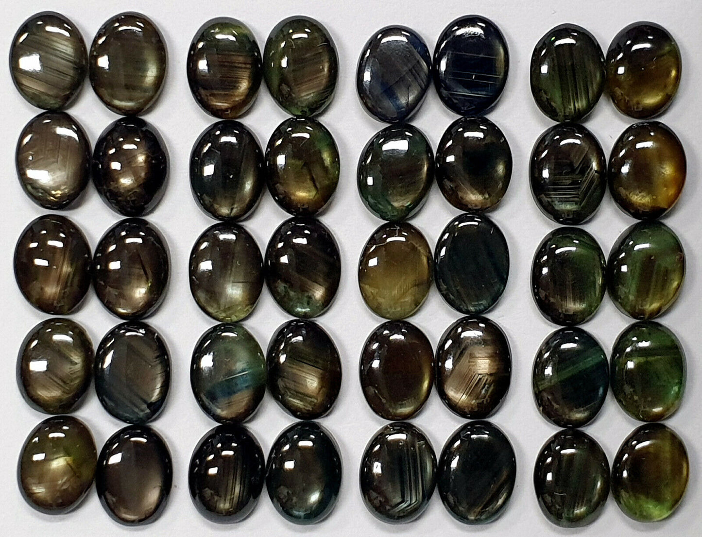 53404 - Lott på 10 naturlige australske svarte stjerne safirer 8x6 mm ovale til salgs