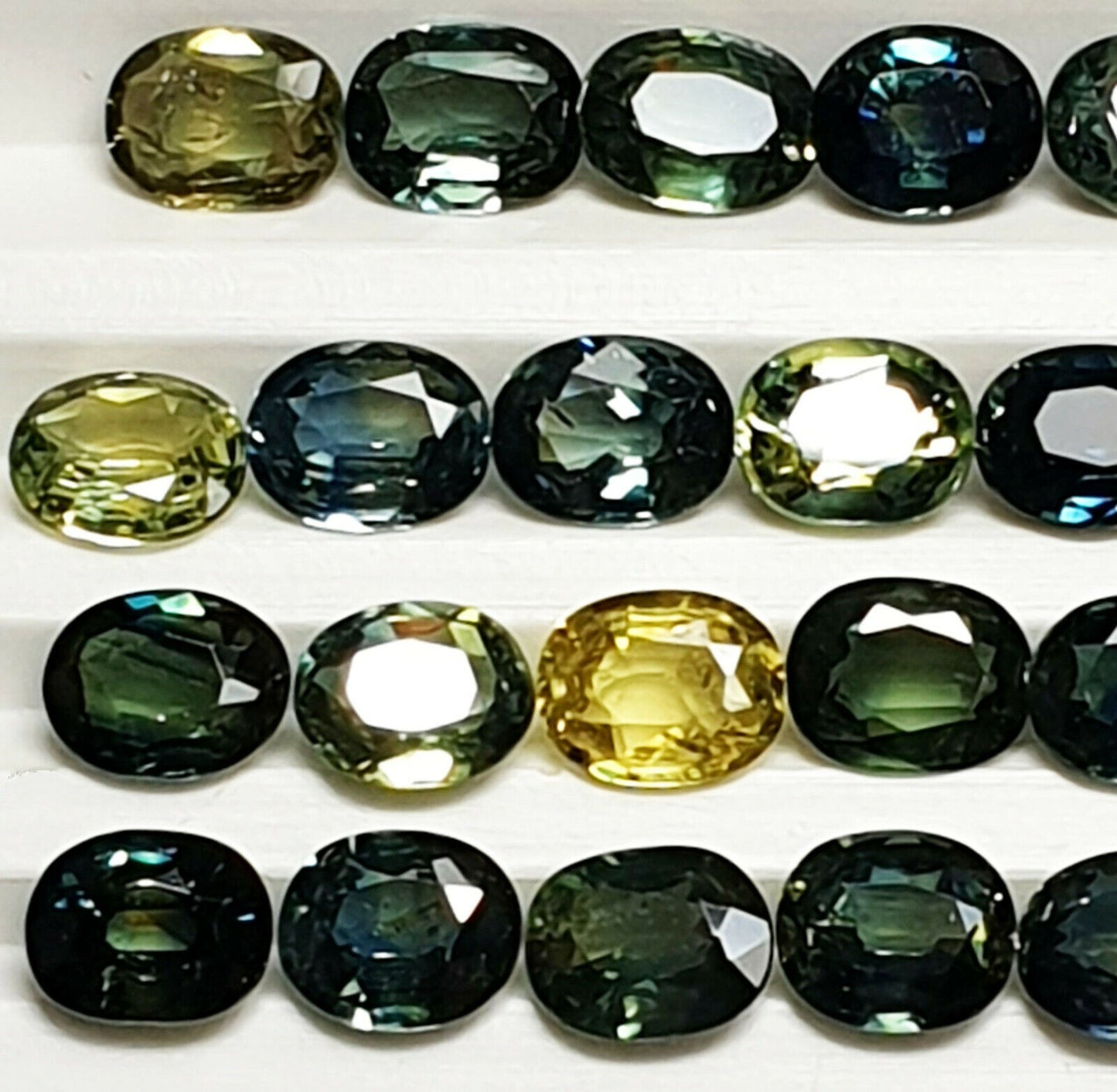52219 - 40 Oval Cut Aussie Teal, Green, Yellow, Parti Color Sapphires 19.47 cts