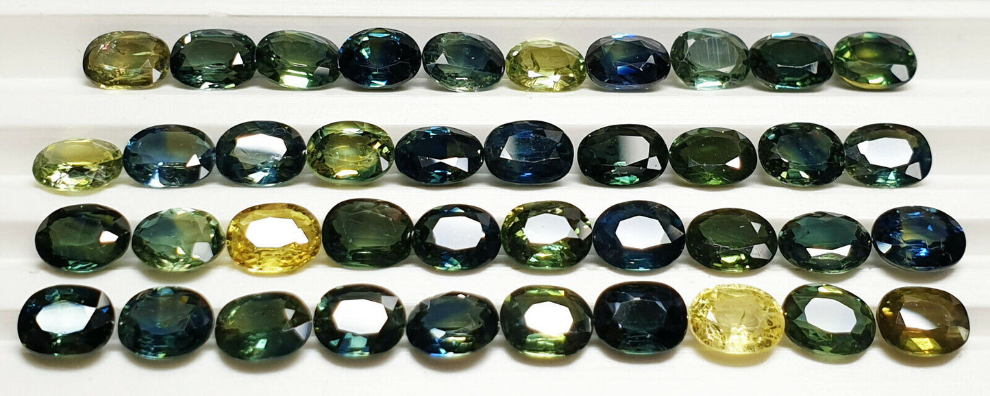 52219 - 40 Oval Cut Aussie Teal, Green, Yellow, Parti Color Sapphires 19.47 cts