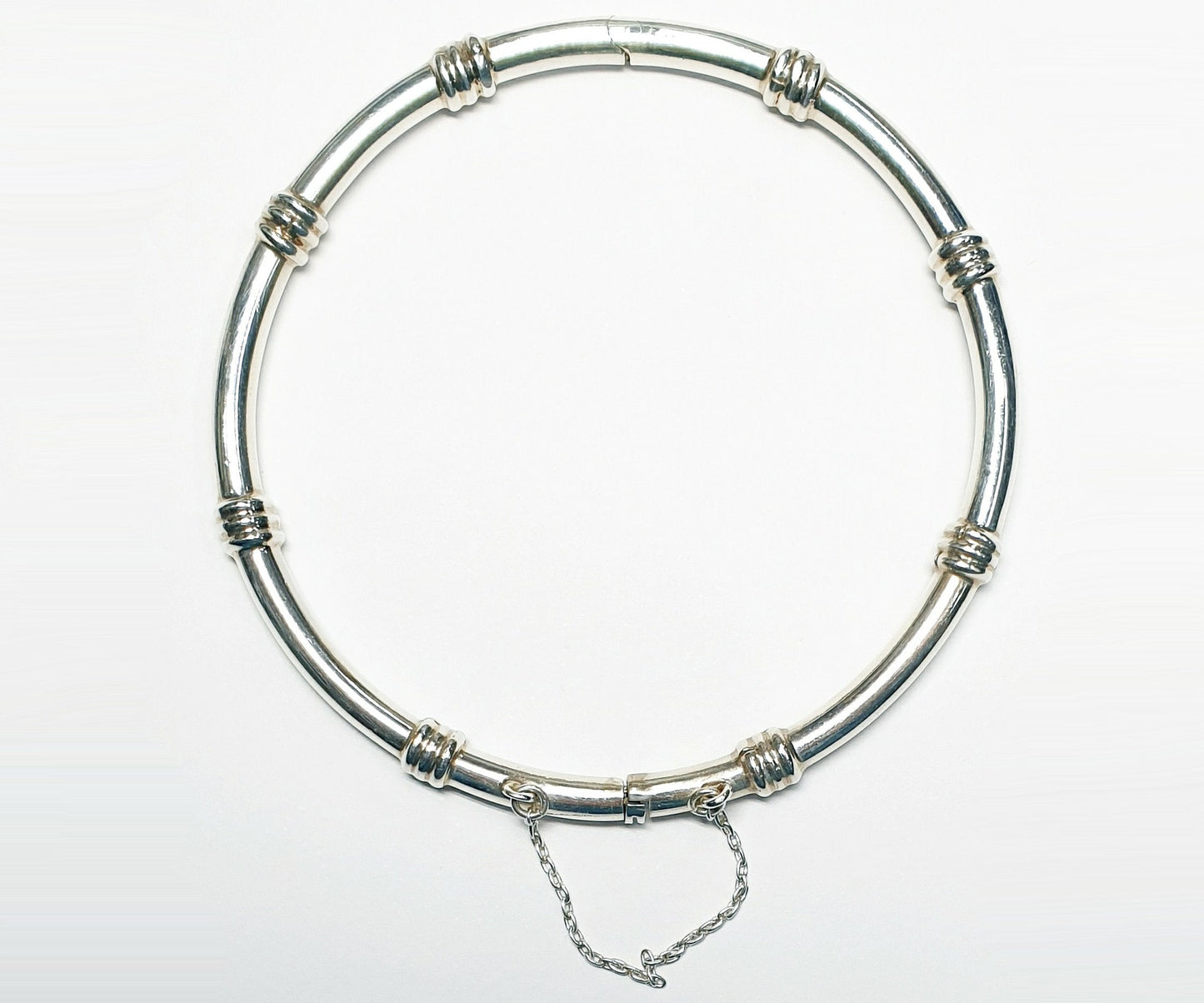 11912.0 - Sterling Silver 4.4 mm Round Tube Hinged Bangle with Safety Chain 65 mm Internal Diameter when closed About 15 grams