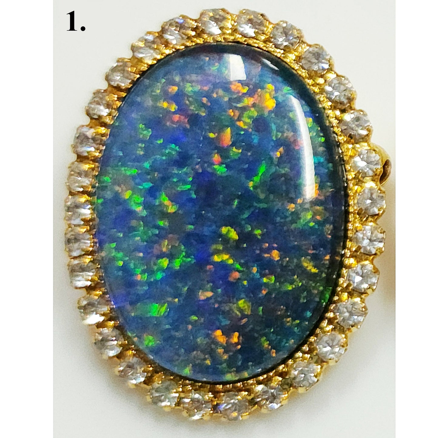 53662.0 - Gullfarget brosje sett med Swarovski-rhinestones som omgir en stor høykvalitets 25 x 18 mm ovalskåret australsk opaltriplett