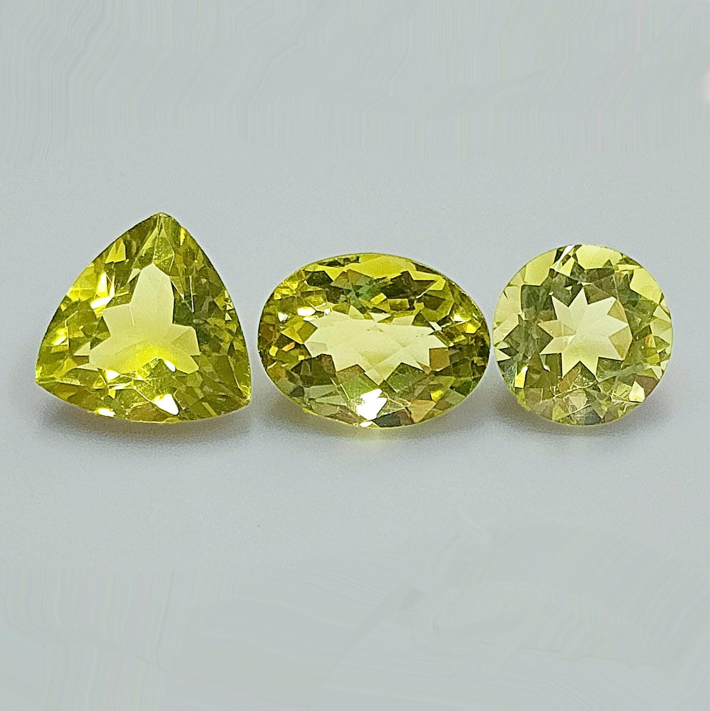 53950.0 - Three Lemon Quartz One Round Cut 11.8 mm 5.86cts One Triliant Cut 13.8 mm 7.61cts One Checker Board Cut Oval 12.5 x 11.5 x 9.2 mm
