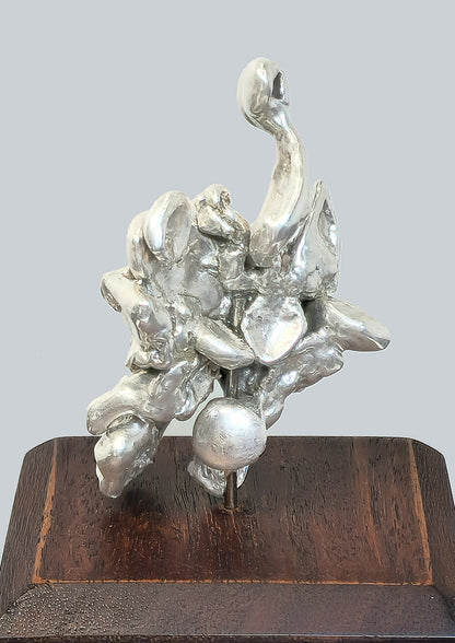 54450.0 - Abstract figurine in pure Silver on wooden block