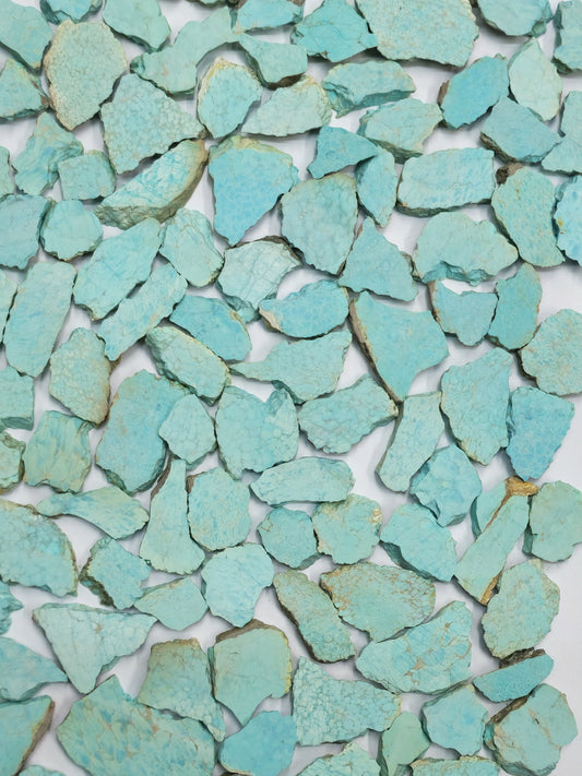 Slices of very rare Amaroo Australian Turquoise on a white background