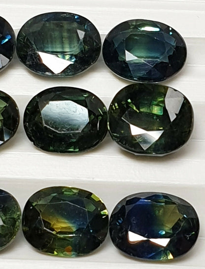 52213 - 24 Oval Cut Australian Teal, GreenS, Parti Coloured Sapphires 21.06 cts