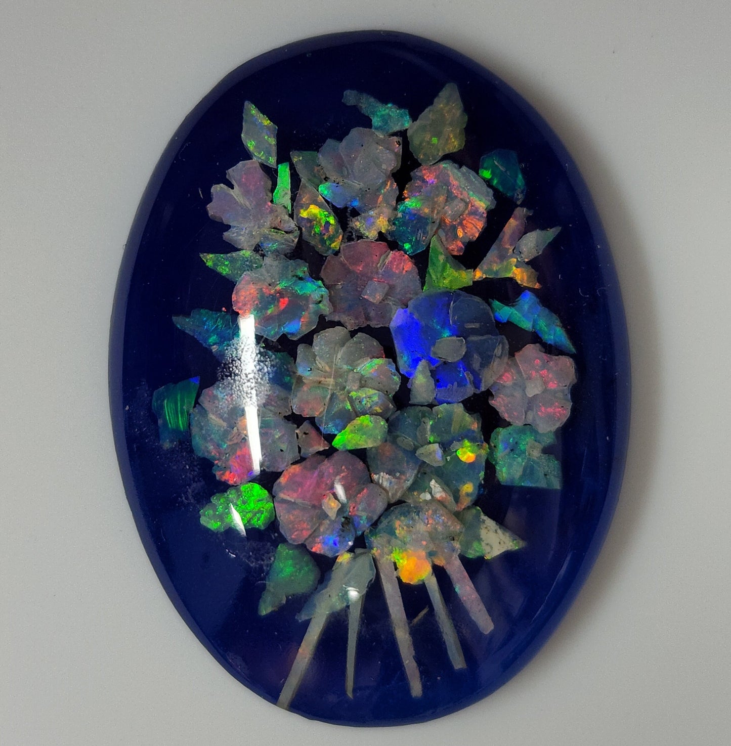 53675.0 - A Boquet of Flowers Created with Carved Australian Opal Chips embedded in Resin against a Blue Background 40x30 mm