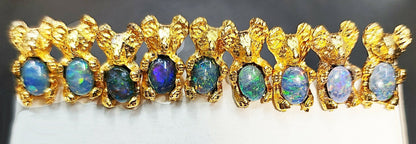 08554.0 - Gold Plated Stick Pins with Koala holding a 7 x 5 mm Oval Cut Australian Opal Triplet for sale About 50 mm long including Bullet