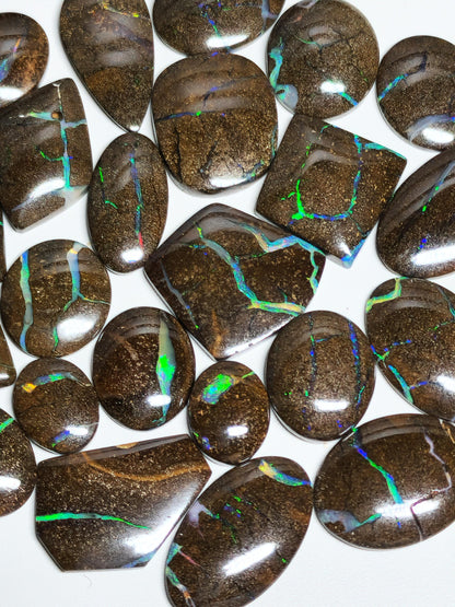 54157.0 - 25 piece lot of rare 1970's Superbly polished Australian Boulder Opal Sizes from 13x10 mm to 25x15 mm 3.0 - 3.5mm thick Flat backs
