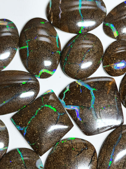 54157.0 - 25 piece lot of rare 1970's Superbly polished Australian Boulder Opal Sizes from 13x10 mm to 25x15 mm 3.0 - 3.5mm thick Flat backs