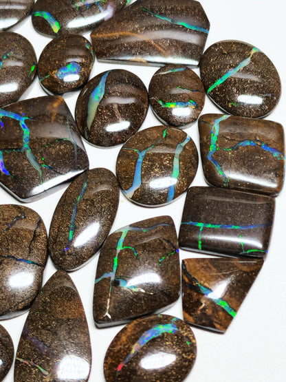 54157.0 - 25 piece lot of rare 1970's Superbly polished Australian Boulder Opal Sizes from 13x10 mm to 25x15 mm 3.0 - 3.5mm thick Flat backs