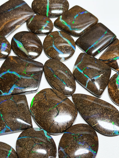 54157.0 - 25 piece lot of rare 1970's Superbly polished Australian Boulder Opal Sizes from 13x10 mm to 25x15 mm 3.0 - 3.5mm thick Flat backs