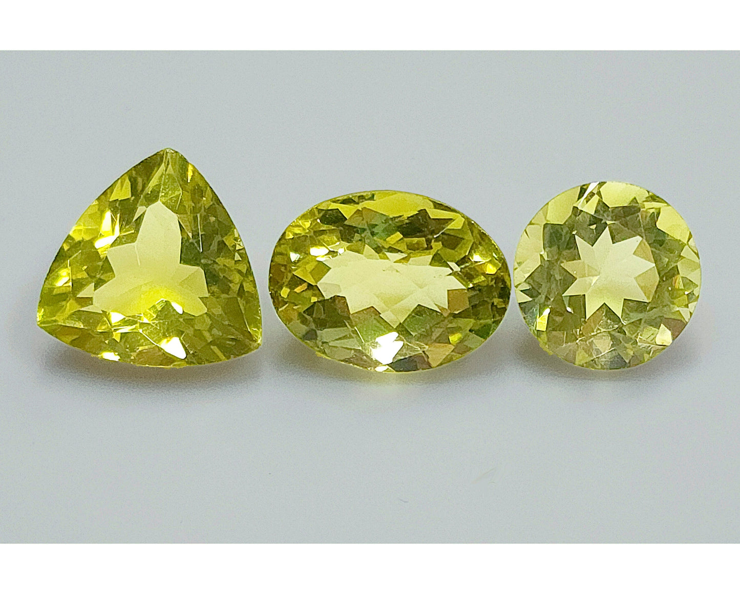 53950.0 - Three Lemon Quartz One Round Cut 11.8 mm 5.86cts One Triliant Cut 13.8 mm 7.61cts One Checker Board Cut Oval 12.5 x 11.5 x 9.2 mm