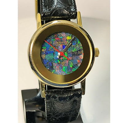 54181.0 - "Australia" Opal Watch with Natural Australian Opal Gold rim with no numbers Black leather strap Japanese movement Water resistant
