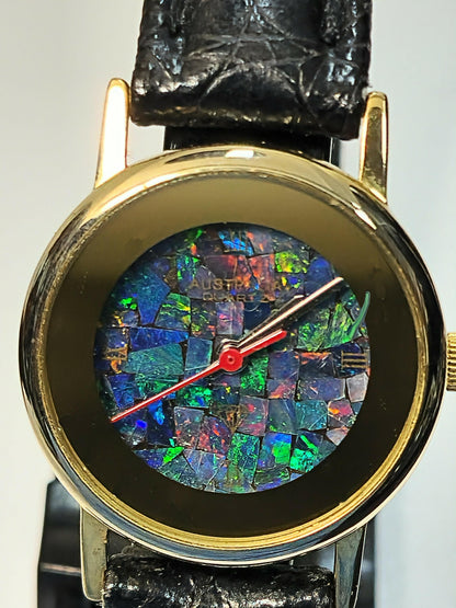 54181.0 - "Australia" Opal Watch with Natural Australian Opal Gold rim with no numbers Black leather strap Japanese movement Water resistant