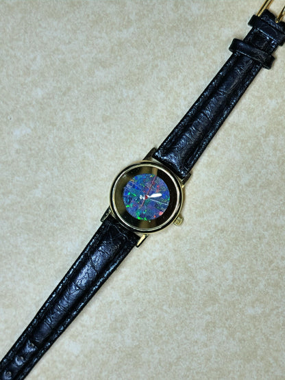 54181.0 - "Australia" Opal Watch with Natural Australian Opal Gold rim with no numbers Black leather strap Japanese movement Water resistant