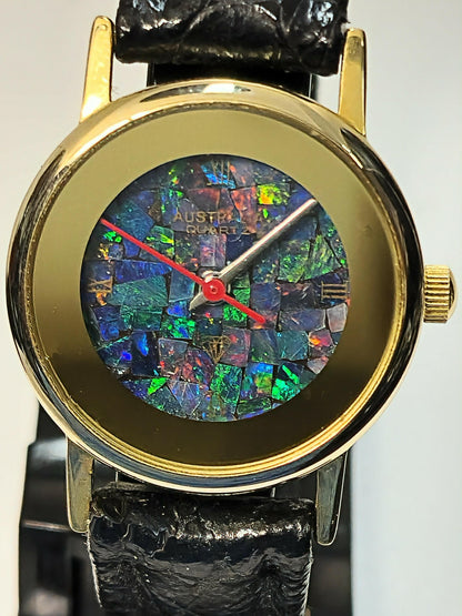 54181.0 - "Australia" Opal Watch with Natural Australian Opal Gold rim with no numbers Black leather strap Japanese movement Water resistant