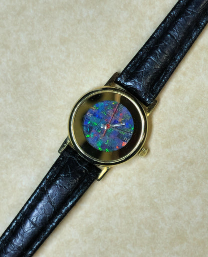 54181.0 - "Australia" Opal Watch with Natural Australian Opal Gold rim with no numbers Black leather strap Japanese movement Water resistant