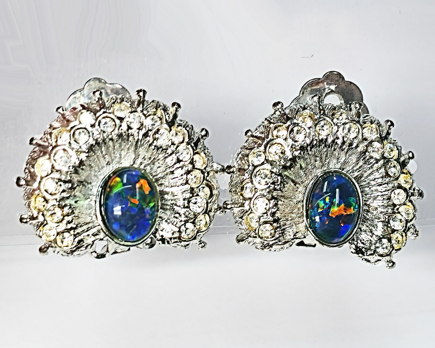 04257.2 - Silver Coloured "Peacock" Clip On Earrings set with Rhinestones and high quality 8 x 6 mm Oval Cut Natural Australian Opal Triplet