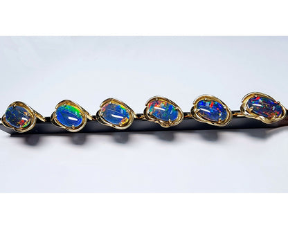 04749.0 - 14 Kt gult gullringsett med en 13 x 8 mm (0,51x0,32 tommer) australsk opaltriplett Totalvekt er omtrent 3,8 gr (19 cts)