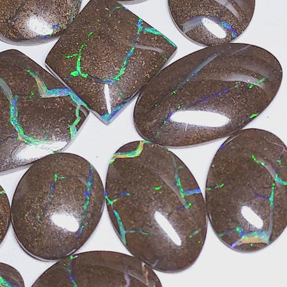 54157.0 - 25 piece lot of rare 1970's Superbly polished Australian Boulder Opal Sizes from 13x10 mm to 25x15 mm 3.0 - 3.5mm thick Flat backs