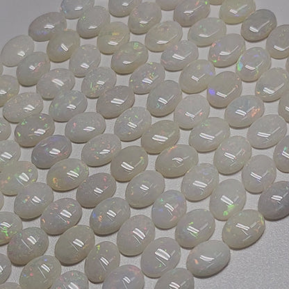 54021.0 - 8x6 mm Wholesale Australian Solid White Oval Cut Cabochon Opal from 1980s for sale All with colour From 1.5 mm to 3.0 mm thick